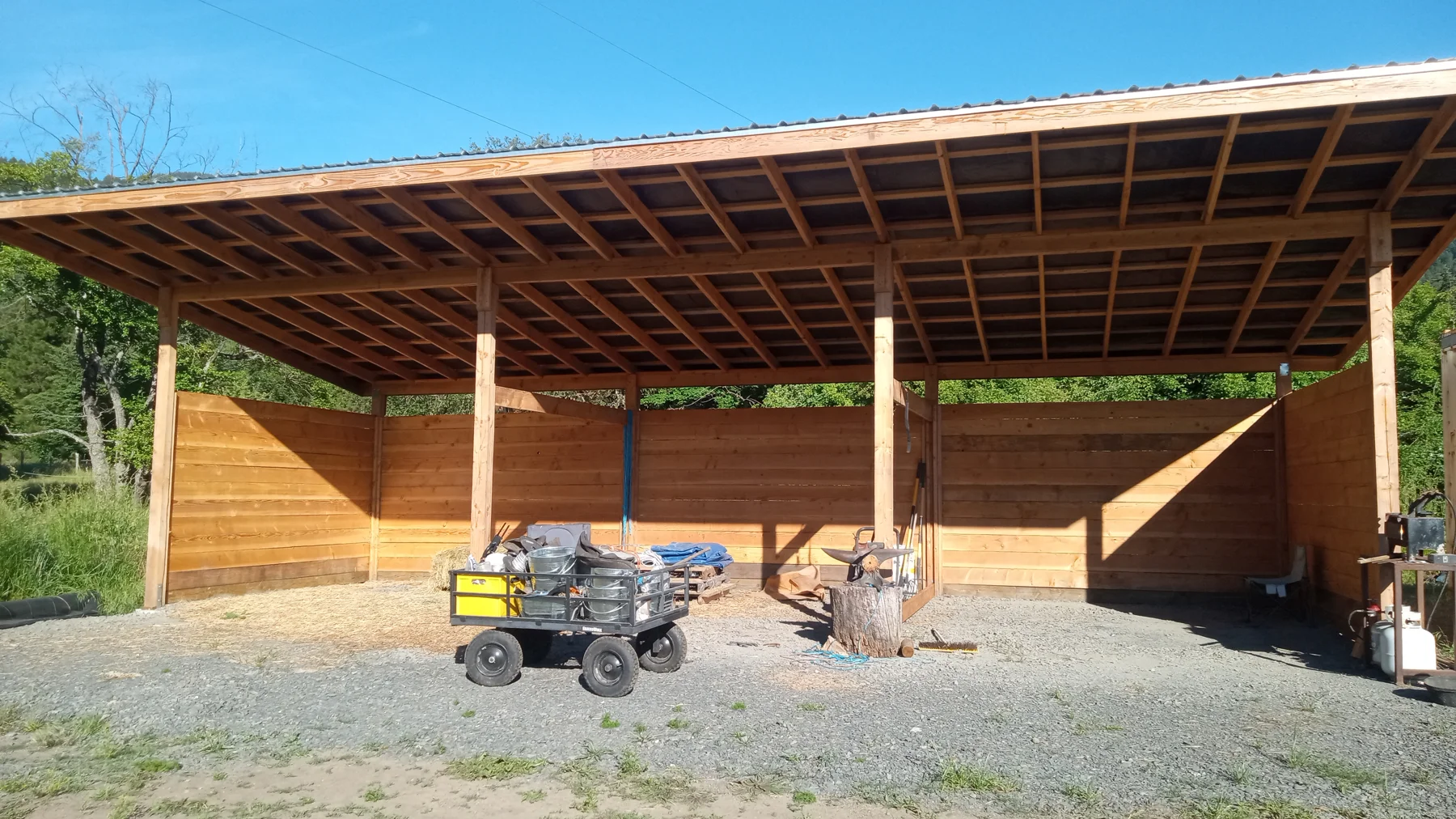 Long timber shelter with several open bays